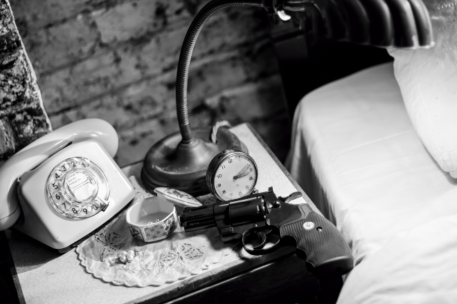 Gun on bedside table. Film Noir